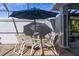 Covered patio with table and chairs, perfect for outdoor dining at 3765 John Anderson Dr, Ormond Beach, FL 32176