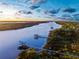 Aerial view of waterfront property with boat docks and tranquil river at 3765 John Anderson Dr, Ormond Beach, FL 32176