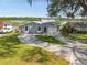 Lakefront home with circular driveway and two-car garage at 711 Candyce Ave, Lakeland, FL 33815