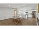 Modern kitchen and dining area with white cabinets, stainless steel appliances, and an island at 711 Candyce Ave, Lakeland, FL 33815