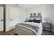 Bedroom with gray bedding and wood flooring at 711 Candyce Ave, Lakeland, FL 33815