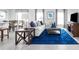 Spacious living room with blue area rug, sofa, and entertainment center at 1235 Tank Trl, Haines City, FL 33844