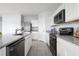 Modern kitchen with stainless steel appliances and granite countertops at 1235 Tank Trl, Haines City, FL 33844