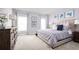 Main bedroom featuring a king-size bed, dresser, and plenty of natural light at 1235 Tank Trl, Haines City, FL 33844