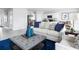 Living area featuring a light sofa and ottoman, plus views into the kitchen at 1235 Tank Trl, Haines City, FL 33844
