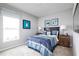 bedroom with blue bedding, nightstands, and penguin art at 1235 Tank Trl, Haines City, FL 33844