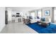 Open living room with blue rug, comfy sofa, and kitchen views at 1235 Tank Trl, Haines City, FL 33844