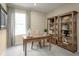 Home office with built-in shelving and a writing desk at 3022 Ruby Falls Dr, Deland, FL 32724