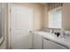 Functional laundry room with washer, dryer, and storage at 3022 Ruby Falls Dr, Deland, FL 32724