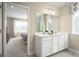Double vanity bathroom with access to a bedroom and shower at 3022 Ruby Falls Dr, Deland, FL 32724