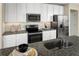 Modern kitchen with stainless steel appliances and granite countertops at 3022 Ruby Falls Dr, Deland, FL 32724
