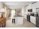 Open concept kitchen with island and stainless steel appliances at 3022 Ruby Falls Dr, Deland, FL 32724