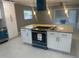 Kitchen island with granite countertop and teal appliances at 3062 Rio Ln, Orlando, FL 32805
