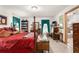Large main bedroom with a post bed and ensuite bathroom at 4920 Sw 78Th Ave, Bushnell, FL 33513