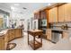 Open kitchen with a large island, stainless steel appliances, and lots of natural light at 4920 Sw 78Th Ave, Bushnell, FL 33513