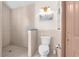 Walk-in shower and toilet in a tiled bathroom at 4920 Sw 78Th Ave, Bushnell, FL 33513