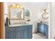 Double vanity bathroom with blue cabinets and oval mirror at 4920 Sw 78Th Ave, Bushnell, FL 33513