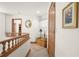 Upper hallway with wooden railing and decorative details at 4920 Sw 78Th Ave, Bushnell, FL 33513