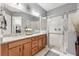 Double vanity bathroom with granite countertop and walk-in shower at 2541 Yellow Brick Rd, Saint Cloud, FL 34772