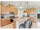 Modern kitchen with granite island, stainless steel appliances, and wood cabinets at 2541 Yellow Brick Rd, Saint Cloud, FL 34772