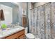 Clean bathroom with granite countertop and patterned shower curtain at 2541 Yellow Brick Rd, Saint Cloud, FL 34772