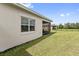 Landscaped backyard with a screened patio and privacy fence at 2541 Yellow Brick Rd, Saint Cloud, FL 34772