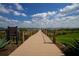 Picturesque lakeside boardwalk leading to a gazebo at 2541 Yellow Brick Rd, Saint Cloud, FL 34772