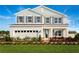 Two-story home with gray siding, shutters, and a landscaped lawn at 5706 Freshwater Canyon Dr, St Cloud, FL 34771
