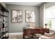 Home office with a large wooden desk, bookshelves, and artwork at 5706 Freshwater Canyon Dr, St Cloud, FL 34771