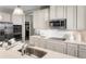 Modern kitchen with white cabinets, stainless steel appliances, and a quartz countertop at 5706 Freshwater Canyon Dr, St Cloud, FL 34771