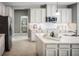 Modern kitchen with white cabinets, quartz countertops, and a kitchen island at 5706 Freshwater Canyon Dr, St Cloud, FL 34771