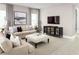 Living room featuring beige sofas, a large TV, and a stylish media cabinet at 5706 Freshwater Canyon Dr, St Cloud, FL 34771