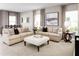 Spacious living room with beige sofas, patterned pillows, and a large art piece at 5706 Freshwater Canyon Dr, St Cloud, FL 34771