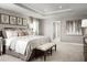 Spacious main bedroom with large bed, sitting bench and en-suite bathroom at 5706 Freshwater Canyon Dr, St Cloud, FL 34771