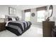 Comfortable bedroom with a grey and white striped bedding at 360 Crossings Ave, St Cloud, FL 34771