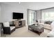 Spacious living room featuring a sofa, armchair, and large TV at 360 Crossings Ave, St Cloud, FL 34771