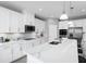 Modern kitchen with white cabinets, large island with quartz countertop at 360 Crossings Ave, St Cloud, FL 34771