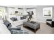 Open living room featuring a comfortable sofa and view into kitchen at 360 Crossings Ave, St Cloud, FL 34771