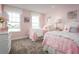 Charming bedroom with two twin beds and pink bedding at 360 Crossings Ave, St Cloud, FL 34771