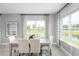Bright dining room with a table and four chairs overlooking a tranquil view at 360 Crossings Ave, St Cloud, FL 34771