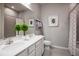 Clean bathroom with double vanity, white cabinets, and a shower at 5769 Anders Way, St Cloud, FL 34771