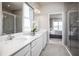 Elegant bathroom with double vanity, large shower, and view of bedroom at 5769 Anders Way, St Cloud, FL 34771