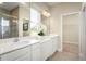 Double vanity bathroom with large mirror and walk-in shower at 5769 Anders Way, St Cloud, FL 34771