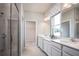 Luxurious bathroom with double sinks, a large shower, and modern fixtures at 5769 Anders Way, St Cloud, FL 34771