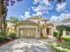 Two-story house with a beige exterior, two-car garage and manicured lawn at 107 Littleton Cir, Deland, FL 32724