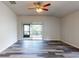 Bright living room with vinyl plank flooring and sliding glass doors to patio at 107 Littleton Cir, Deland, FL 32724