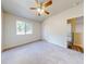 Spacious bedroom with ceiling fan and window at 107 Littleton Cir, Deland, FL 32724