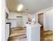 Modern kitchen with white cabinets, island, and stainless steel appliances at 107 Littleton Cir, Deland, FL 32724