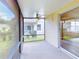 Screened porch with ceiling fan and view of backyard at 107 Littleton Cir, Deland, FL 32724