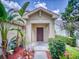 Inviting front entry with a dark brown door, flanked by tropical plants at 107 Littleton Cir, Deland, FL 32724